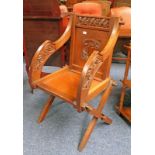 OAK GOTHIC REVIVAL OPEN ARMCHAIR WITH DECORATIVE CARVING & LETTERING ON CROSS SUPPORTS