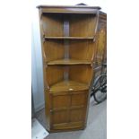 ERCOL ELM CORNER CABINET WITH OPEN SHELVES OVER PANEL DOOR,