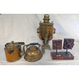 BRASS TEA URN TOGETHER WITH TEA POTS AND DECORATIVE CARVED ORNAMENTS ON STANDS