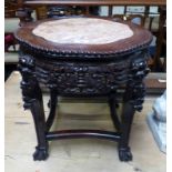 CIRCULAR HARDWOOD CHINESE STAND WITH PINK GRANITE CENTRE ON CARVED SUPPORTS,