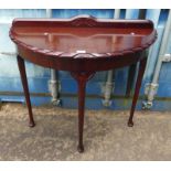 MAHOGANY HALFMOON TABLE ON SHAPED SUPPORTS Condition Report: 89cm wide. 83cm tall.