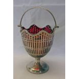 EARLY 20TH CENTURY SILVER SWING HANDLED BON BON BASKET WITH RED GLASS LINER & PIERCED SIDES,