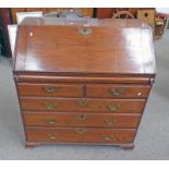 19TH CENTURY OAK BUREAU WITH FITTED INTERIOR BEHIND FALL FRONT OVER 2 SHORT & 3 LONG GRADUATED