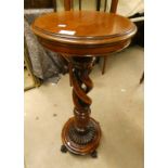 MAHOGANY PLANT STAND ON DECORATIVE COLUMN WITH BALL AND CLAW SUPPORTS.