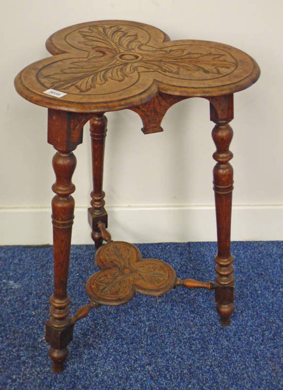 ARTS & CRAFTS STYLE OAK TABLE WITH SHAPED TOP & CARVED DECORATION ON TURNED SUPPORTS,