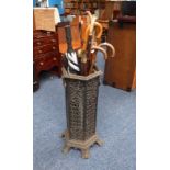 CAST IRON STICK STAND WITH PIERCED DECORATION & GOOD SELECTION OF VARIOUS WALKING STICKS