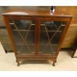 MAHOGANY BOOKCASE WITH 2 ASTRAGAL GLASS PANEL DOORS OVER 2 DRAWERS ON BALL & CLAW SUPPORTS.