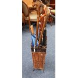WROUGHT IRON & BASKET WORK STICK STAND WITH VARIOUS BROLLIES AND WALKING STICKS