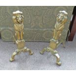 PAIR OF BRASS FIRE DOGS WITH LION DECORATION.
