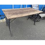 WOODEN GARDEN TABLE WITH PAINTED CAST IRON ENDS,