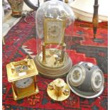 CLOCK IN A DOME CASE, BRASS CASED CARRIAGE CLOCK AND A ROTATING DESK TOP BAROMETER,