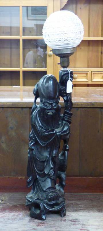 ORIENTAL CARVED HARDWOOD FIGURE OF A PRIEST WITH CUT GLASS GLOBE,