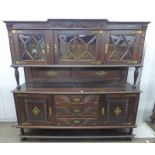 EARLY 20TH CENTURY OAK DRESSER WITH 3 GLASS DOORS OVER DECORATIVE BACK PANEL WITH 3 DRAWERS FLANKED