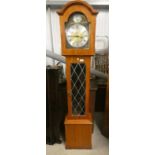 TEAK LONGCASE CLOCK WITH LEADED GLASS PANEL AND METAL DIAL.