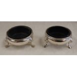 PAIR OF GEORGE II SILVER CIRCULAR SALTS ON PAW FEET BY BENJAMIN CARTWRIGHT,