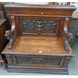 19TH CENTURY SETTLE WITH CARVED DECORATION & LIFT UP SEAT 104CM TALL X 108CM WIDE