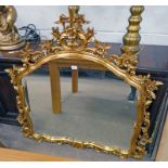 GILT FRAMED OVERMANTLE MIRROR WITH DECORATIVE FLORAL CARVING,