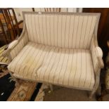 EARLY 20TH CENTURY LIMED OAK FRAMED SETTEE WITH DECORATIVE CARVING ON REEDED SUPPORTS