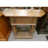 LATE 19TH CENTURY CARVED OAK HALL TABLE WITH SINGLE CUPBOARD DOOR ON PLINTH BASE 84CM TALL X 104CM