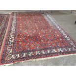 RED GROUND MIDDLE EASTERN CARPET WITH FLORAL DECORATION 230 X 340CM