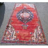 WASHED RED GROUND PERSIAN SAROUK RUG WITH A LARGE CENTRAL MEDALLION 270 X 132CM