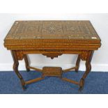 LATE 19TH CENTURY MOORISH STYLE FLIP TOP GAMES TABLE WITH DECORATIVE INLAY AND 2 DRAWERS ON SHAPED