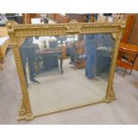 GILT FRAMED OVERMANTLE MIRROR WITH DECORATIVE CARVED FRAME 100 CM TALL X 114 CM WIDE