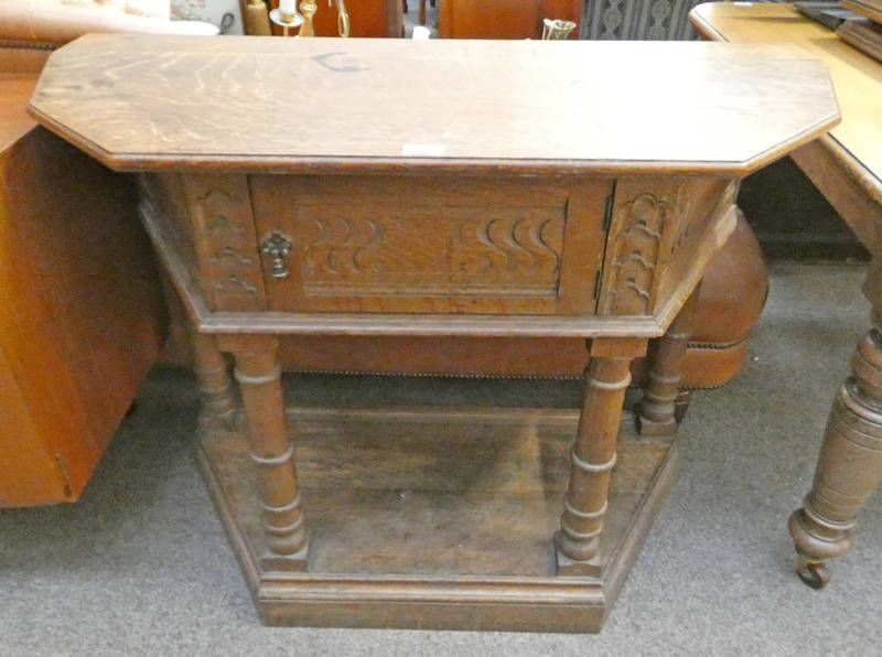 LATE 19TH CENTURY CARVED OAK HALL TABLE WITH SINGLE CUPBOARD DOOR ON PLINTH BASE 84CM TALL X 104CM