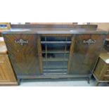 MAHOGANY CABINET WITH CENTRAL GLAZED PANEL DOOR FLANKED BY 2 PANEL DOORS ON SPLAYED SUPPORTS,