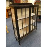 20TH CENTURY DISPLAY CASE ON SHAPED SUPPORTS