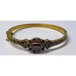 YELLOW METAL GARNET SET HINGED BANGLE - INNER DIAMETER 6CM,