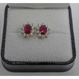 PAIR OF 18CT WHITE GOLD RUBY & DIAMOND CLUSTER EARSTUDS.