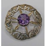 IONA SILVER AMETHYST SET CIRCULAR BROOCH WITH PIERCED DECORATION BY JOHN HART,