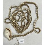 EX SIR RICHARD BARRON COLLECTION, COWRIE SHELL ADORNMENT ON A BOUND COWRIE SHELL STRING,