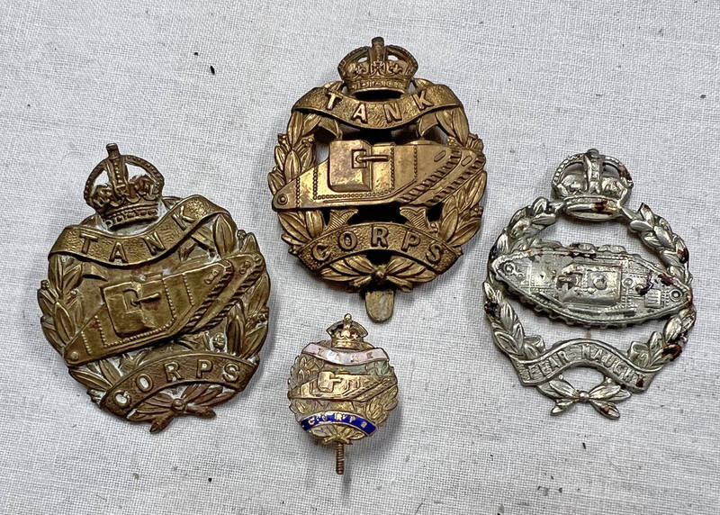 3 TANK CORPS CAP BADGES AND A BRASS AND ENAMEL TANK CORPS LAPEL BADE -4-
