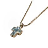 An 18 carat white gold blue topaz cross pendant on an 18 carat white gold chain, pendant length 2.