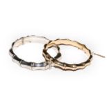 A 9 carat gold bamboo motif hinged bangle, inner measurements 5.9cm by 5.4cm; and a silver bamboo