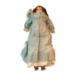 Circa 1900 composition shoulder doll, with fixed glass eyes, painted eyelashes, original brown