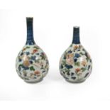 A Pair of Imari Porcelain Bottle Vases, circa 1700, typically painted with flowering tendrils