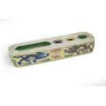 A Chinese Wucai Porcelain Pen Box, Kangxi, of rounded rectangular form with three circular and one