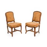 A Pair of Late 19th Century French Beech-Framed Chairs, upholstered in close-nailed brown suede with