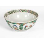 A Chinese Porcelain Bowl, Kangxi, painted in famille verte enamels with flowering branches in