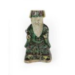 A Chinese Porcelain Figure on an Immortal, Kangxi period, as a seated bearded figure, decorated in