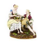 A Meissen Porcelain Figure Group, late 19th century, as a youth and girl sitting on a rocky