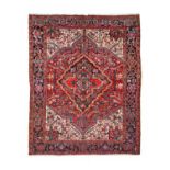 Heriz CarpetNorth West Iran, circa 1930The raspberry field of angular vines centred by a medallion