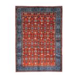 Veramin Carpet Central Iran, circa 1950The brick-red field with columns of flowerheads enclosed by