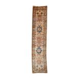 Narrow North-West Persian Runner, circa 1960The camel field with a row of heraldic panels flanked by
