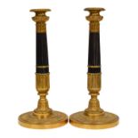 A Pair of French Restoration Period Gilt and Patinated Bronze Candlesticks, with campana sockets,