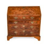 A George II Figured Walnut, Feather-Banded and Crossbanded Bureau, 2nd quarter 18th century, the