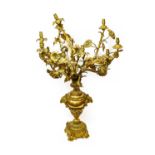 A Gilt Metal Nine-Light Candelabrum, in Louis XV style, as flowers issuing from a baluster vase cast